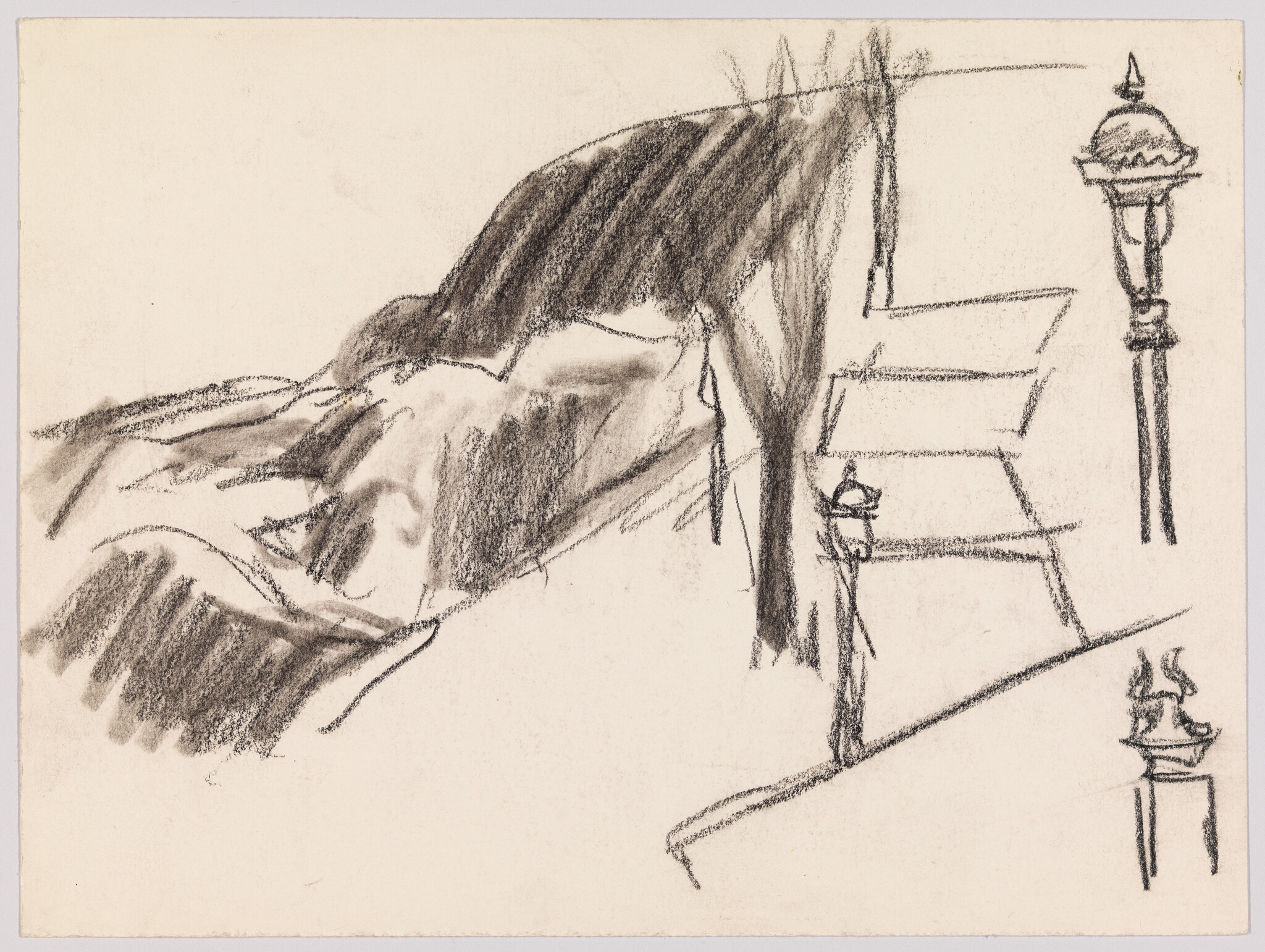 Person standing on steps beside a dark hillside with two decorative lamp posts.