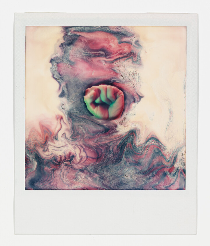 A colorful clenched fist emerges from swirling pink and teal marble-like patterns.