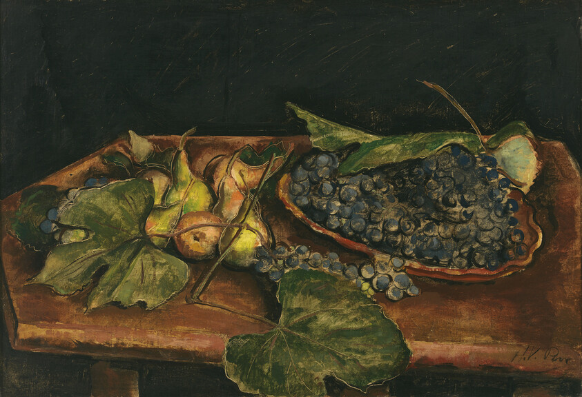 A wooden table holds a cluster of dark grapes and green figs with leafy vines.