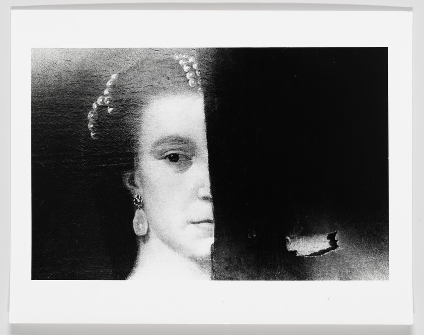 A woman's painted face is half hidden by a dark vertical strip with torn paint.