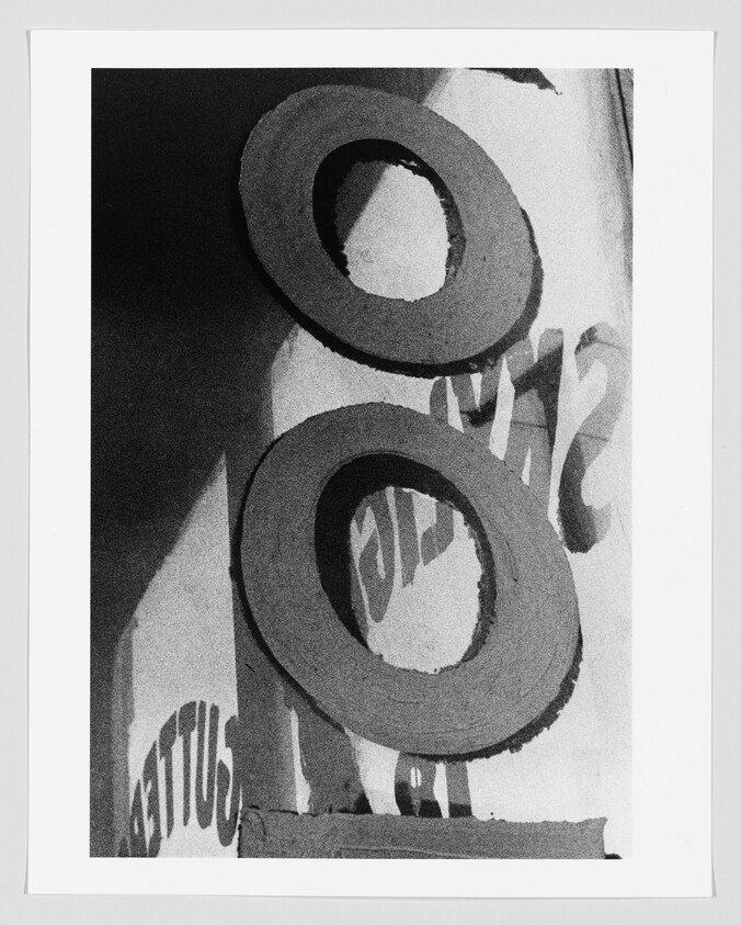 Two large circular foam rings stacked vertically against a printed background with partial text.