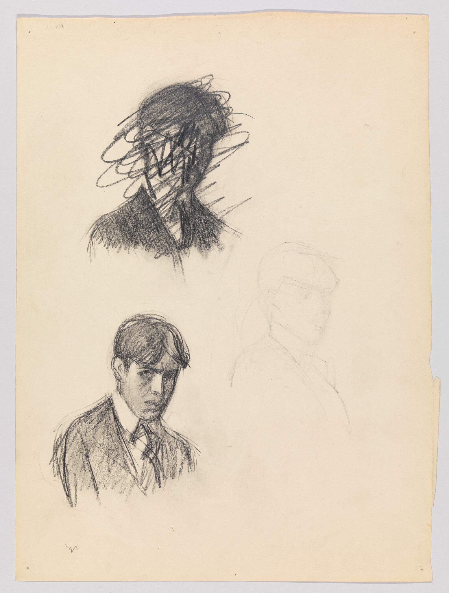 Three pencil head sketches of a young man, one heavily scribbled out and one detailed portrait.