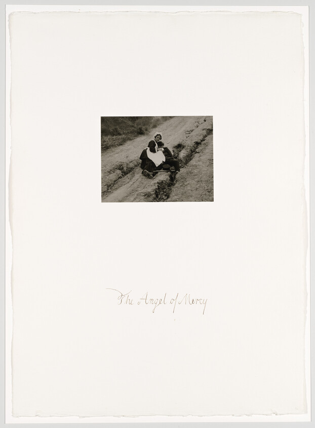 A nurse labeled "The Angel of Mercy" tends to a wounded soldier on a rough dirt road.