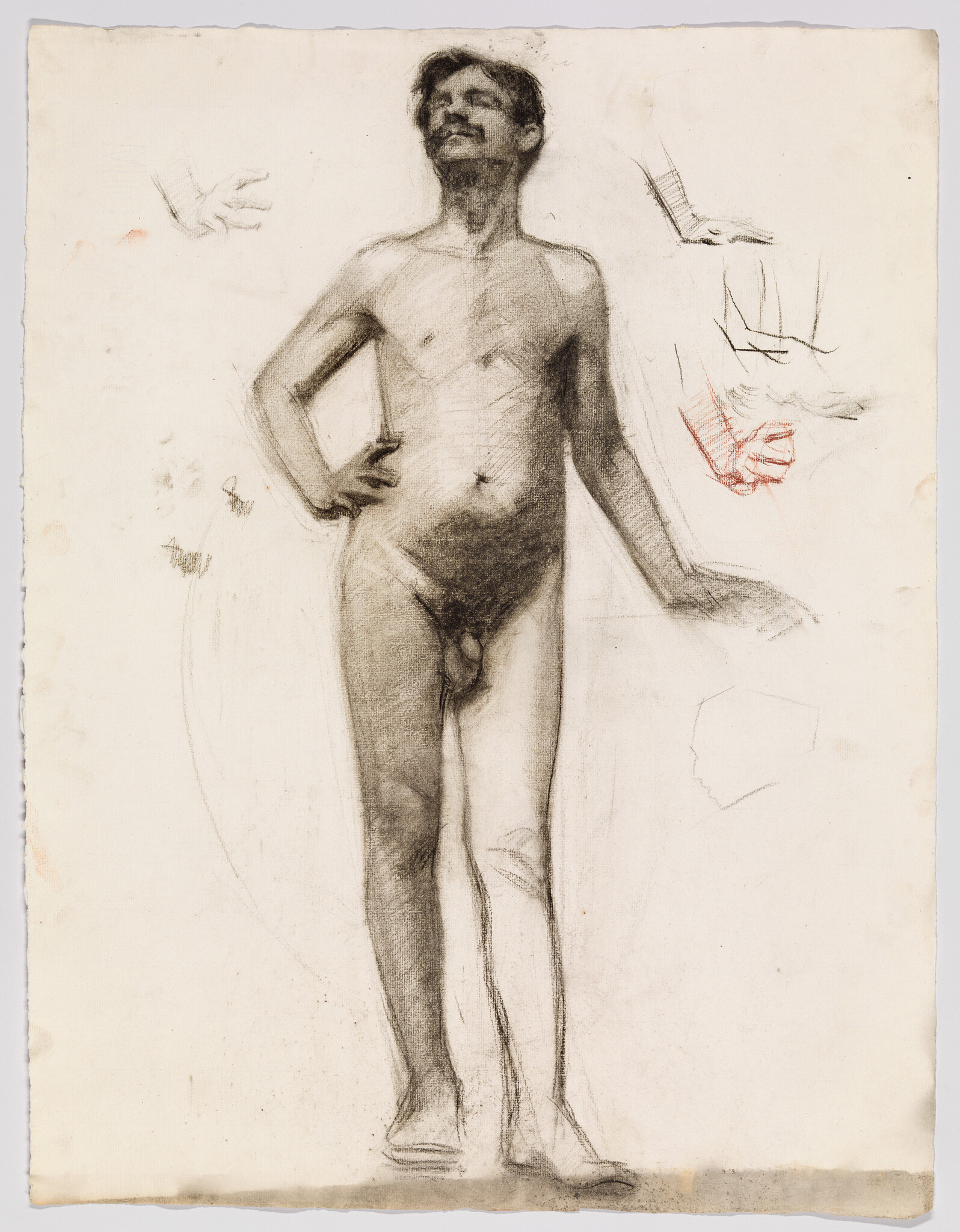 Standing nude man with hand on hip, rough charcoal studies of hands and arm nearby.