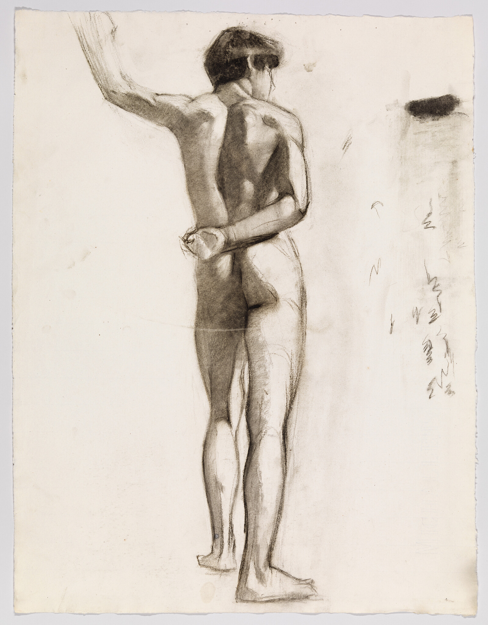 Nude male figure standing from behind with left arm raised and right hand behind back.