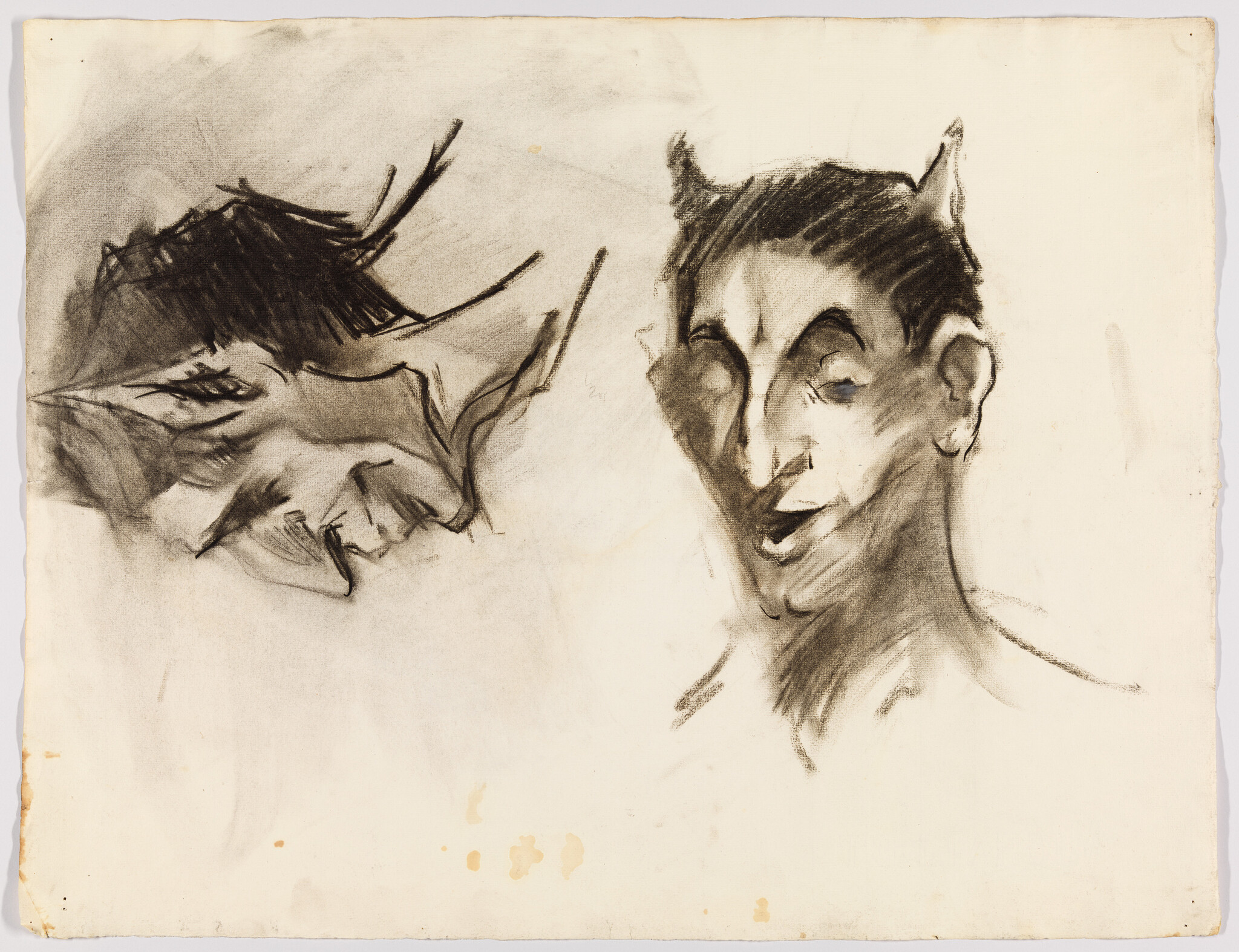 Two charcoal sketches show devilish faces, one in profile and one facing forward with horns.