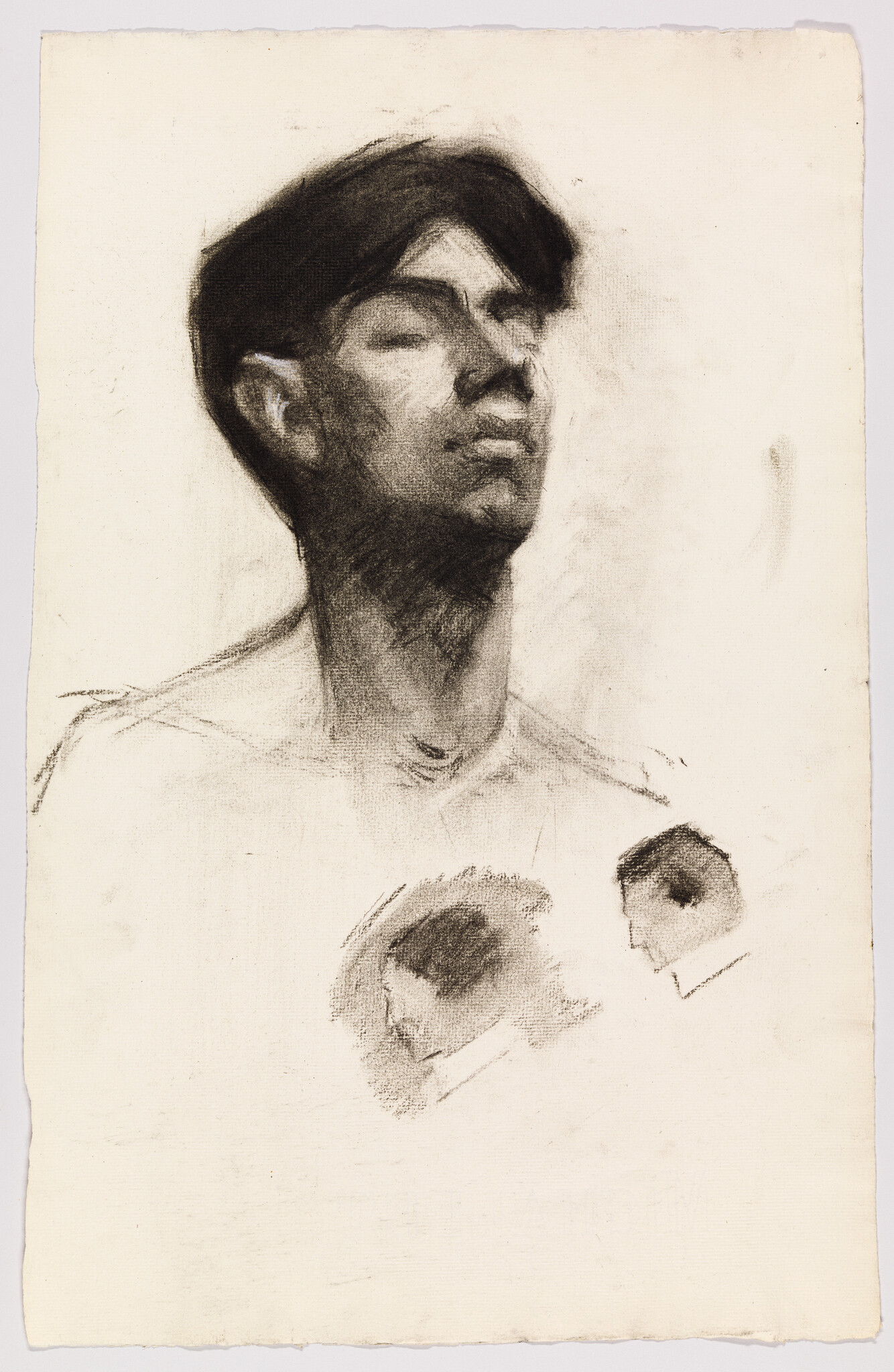 A charcoal sketch of a young man looking upward with two small profile studies below.