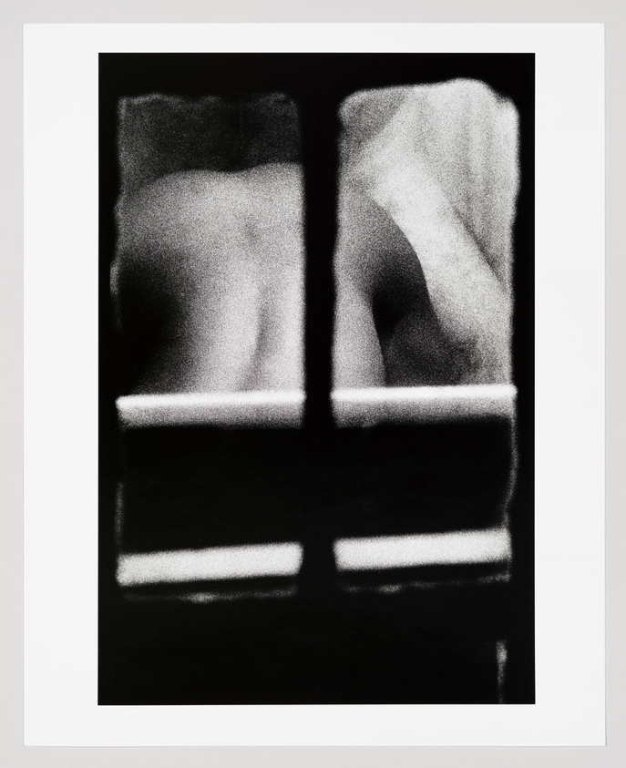 A grainy image seen from a window shows a woman's nude backside as she arches her back