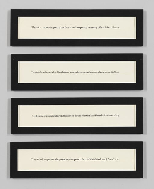 Four narrow black-framed panels displaying short printed quotes mounted vertically on a gray wall.