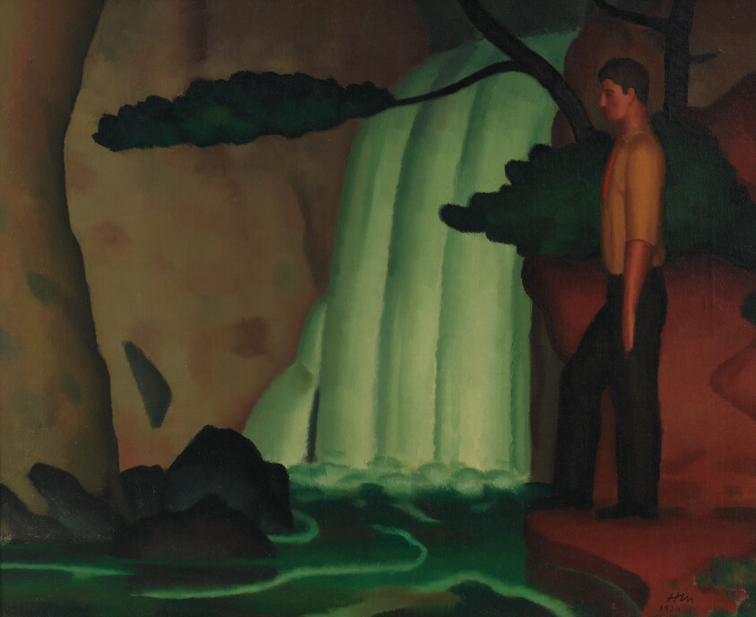 A man stands on a cliff beside a glowing green waterfall in a dark rocky landscape.