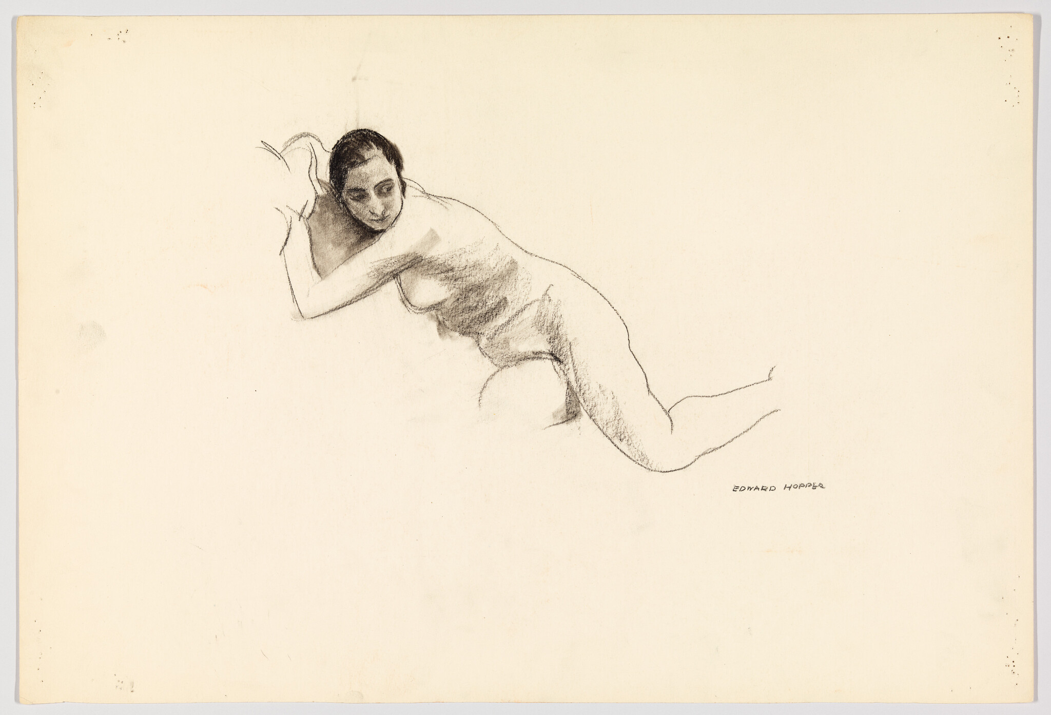 A reclining nude woman rests on her arms in a loose charcoal sketch.