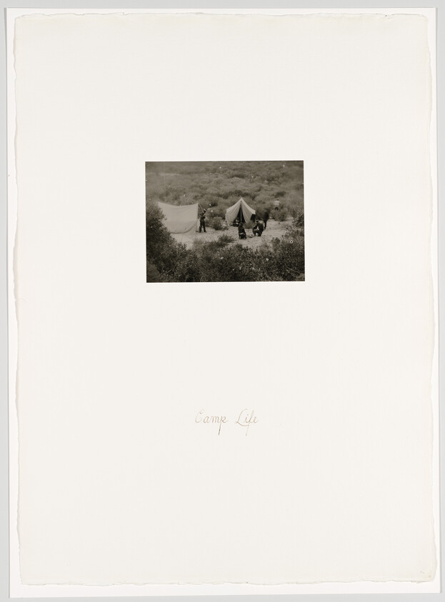 Three people set up tents on a scrubby hillside campsite with the handwritten words camp life.