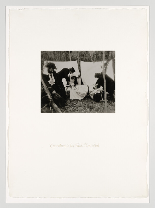 Several medical staff perform a surgical operation on a patient at an outdoor field hospital tent.