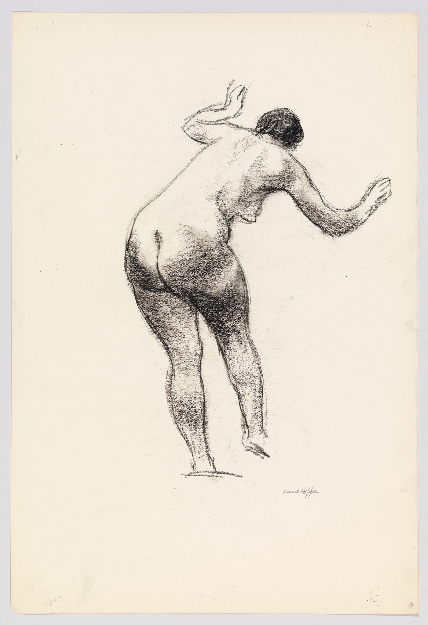 A charcoal sketch of a nude woman seen from behind leaning forward with raised arms.
