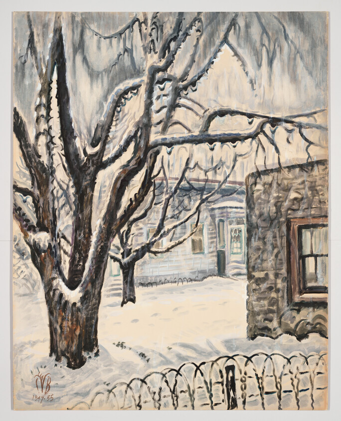 A large snow-covered tree stands in a quiet yard beside a house and picket fence.