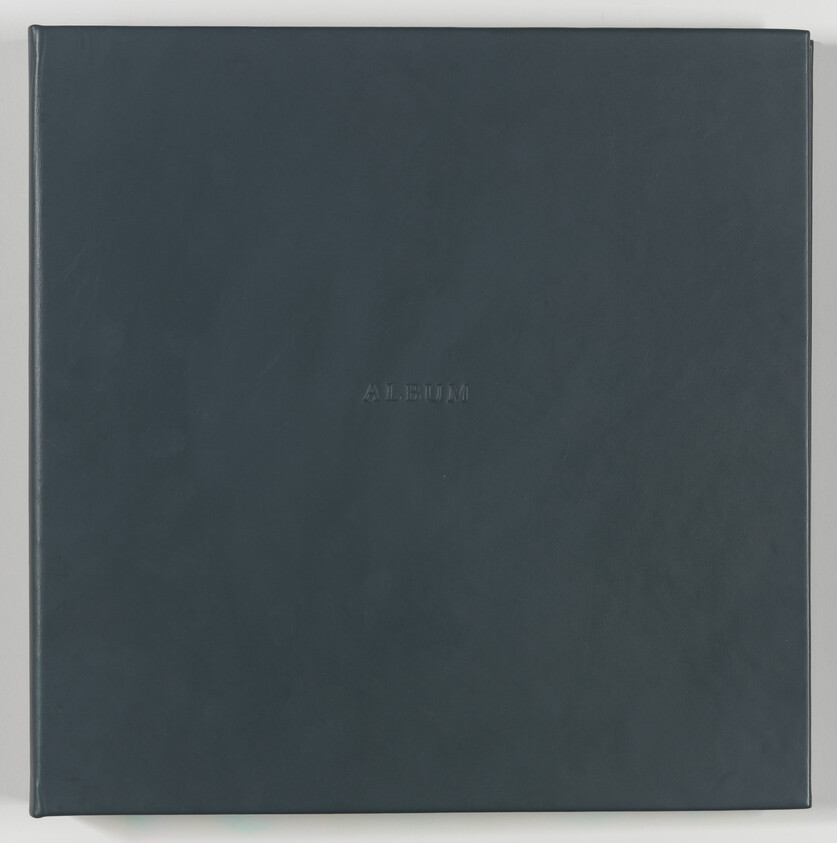 Dark gray photo album with the word "ALBUM" embossed on the center of the cover.
