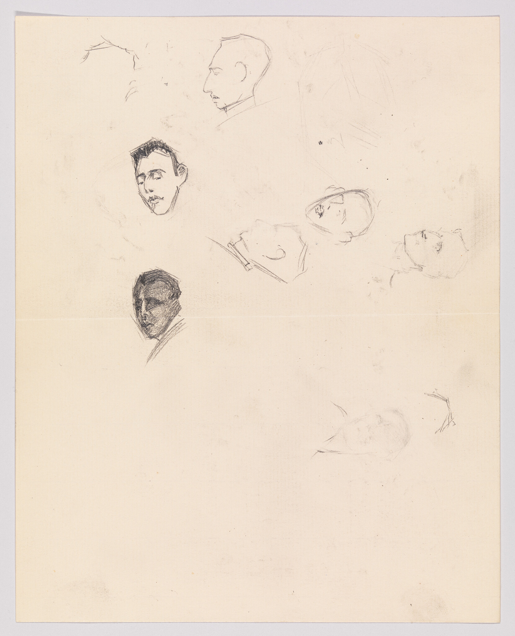 Multiple quick pencil sketches of men's heads and faces scattered across a blank sheet of paper.