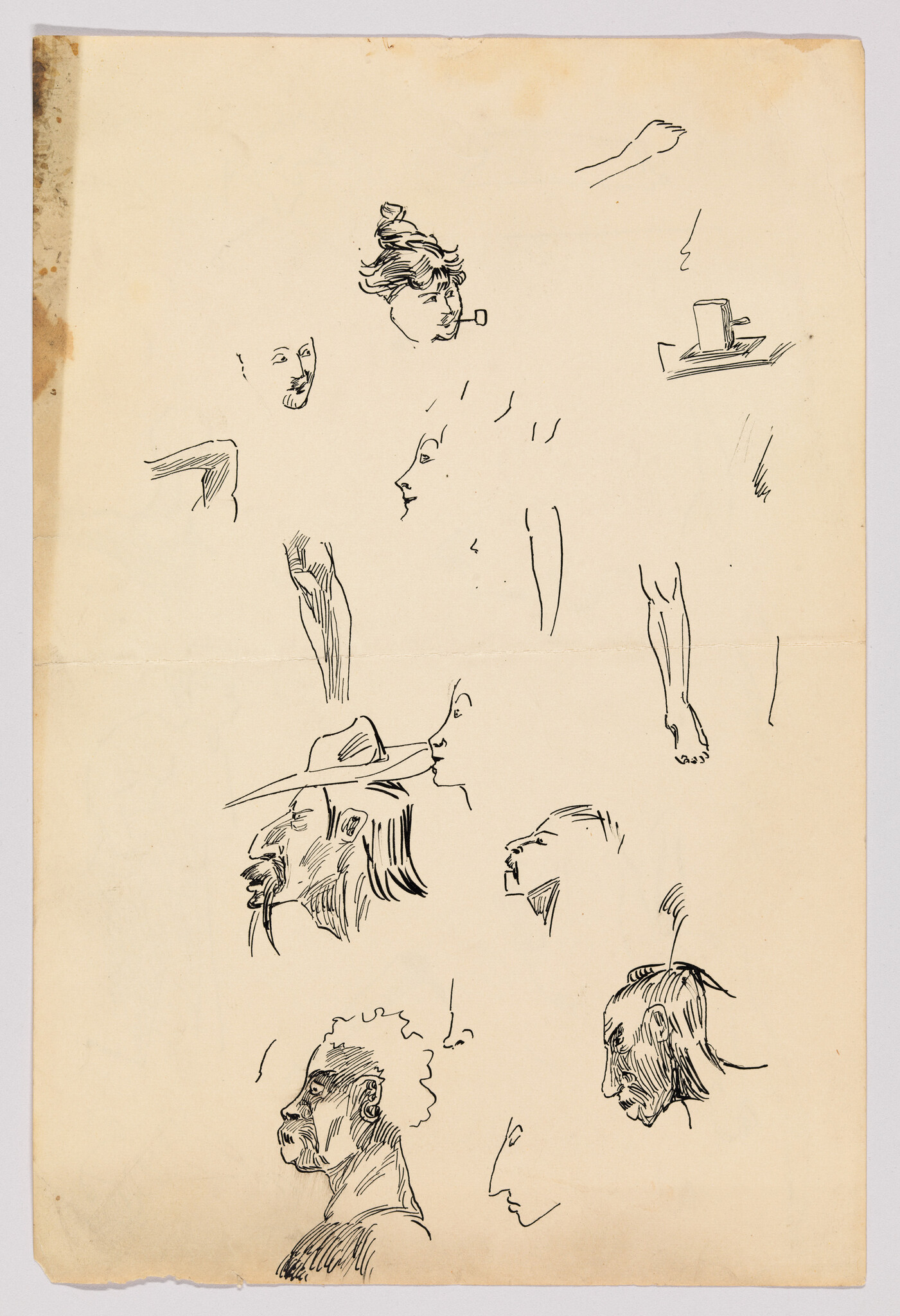 A vintage sheet of paper featuring a collection of ink sketches including various human faces with different expressions, a hand, a top hat on a flat surface, and a few isolated body parts like an arm and a leg. The drawings appear to be practice sketches, possibly by an artist studying human features and anatomy. The paper has aged to a tan color, with some discoloration and wear around the edges.