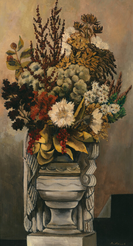 A stone urn holds a tall, dense arrangement of dried and fresh flowers.