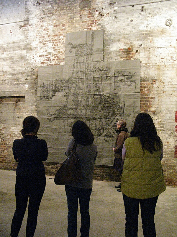 The group tours a former factory that is now a gallery