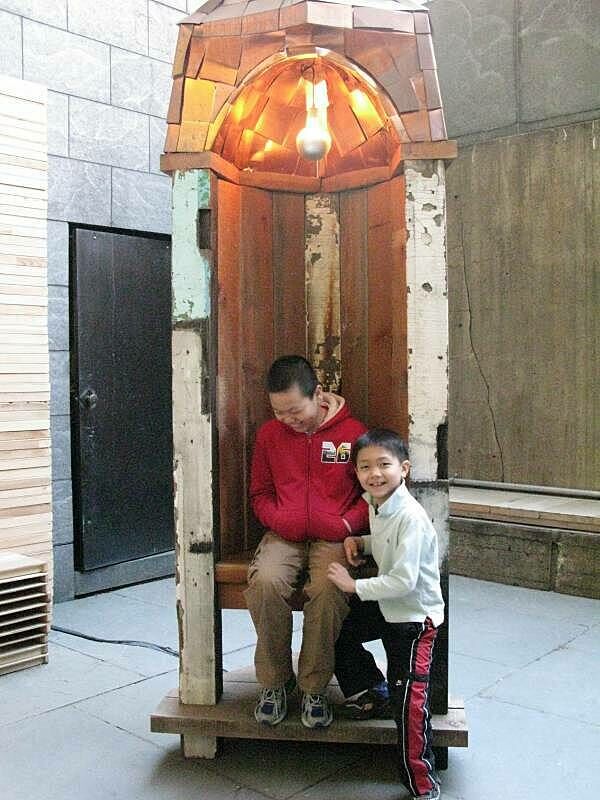 Two children laughing in the sculpture exhibit