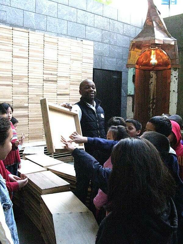 Children touching a piece of wood