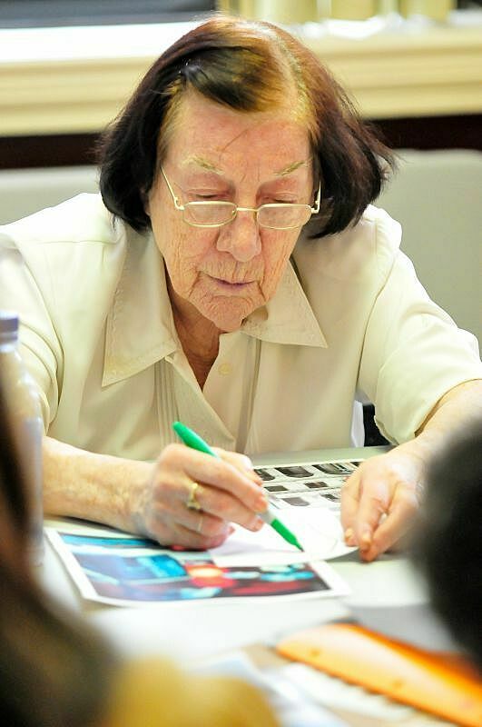 Woman with pen drawing on paper.