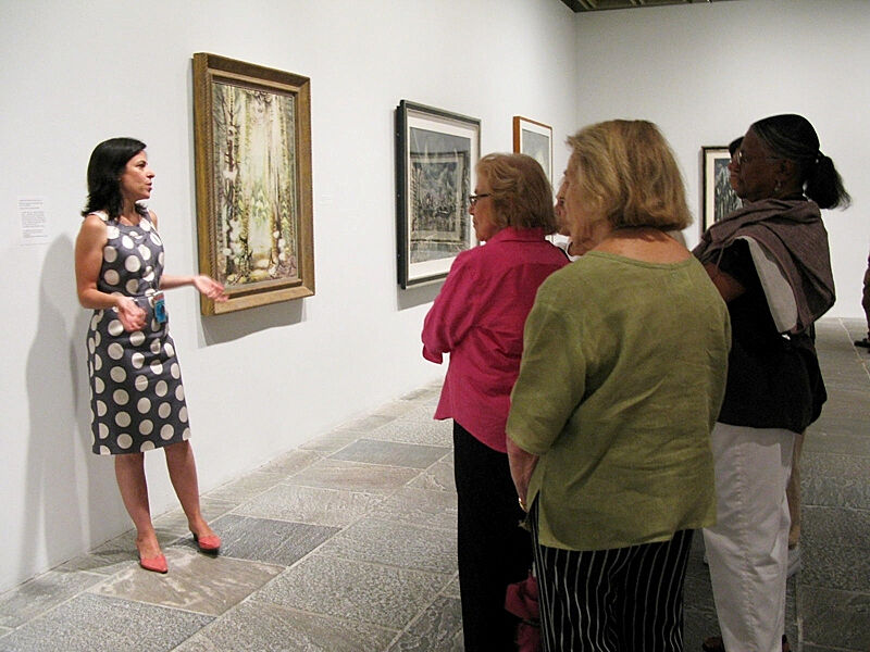 A tour guide talking about artist Charles Burchfield in the gallery