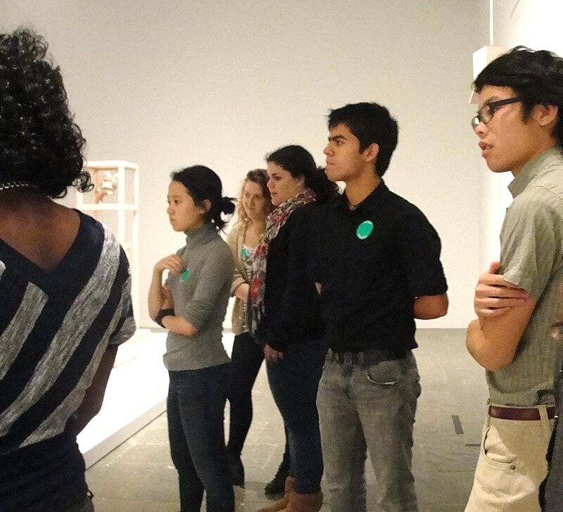teens listening to speaker in gallery