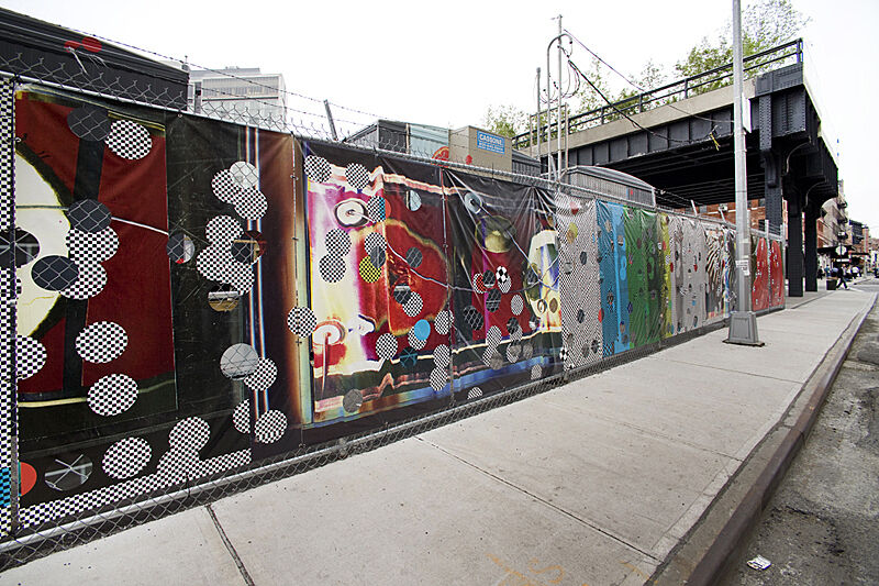 A chain link fence with art covering it