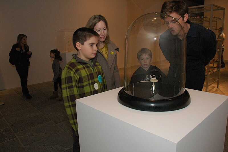 Parents and children explore an exhibit in the gallery.