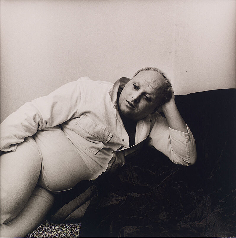 A photograph of Divine reclining.