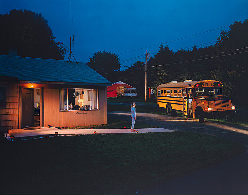 A photograph of a house and a person standing in front of a bus.