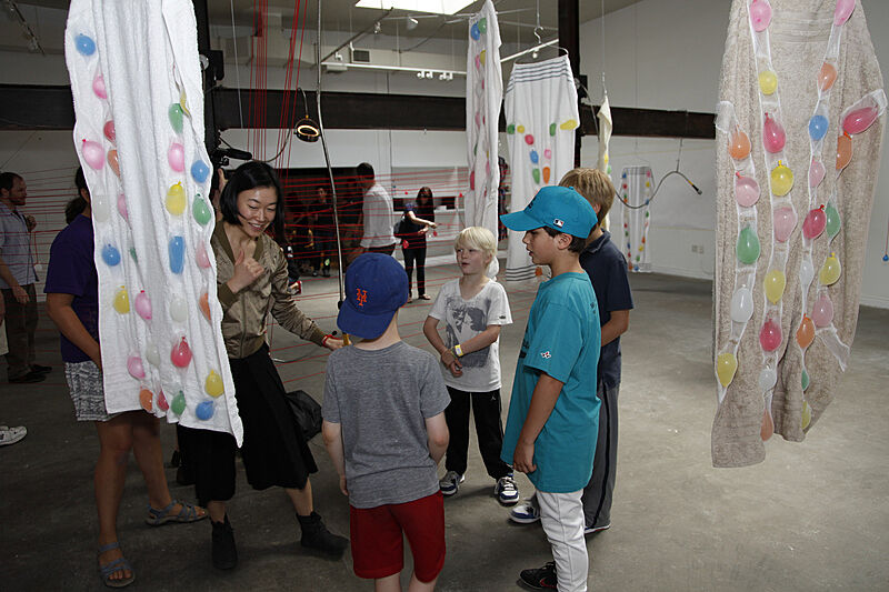The artist shows off her boxing skills to a group of kids.