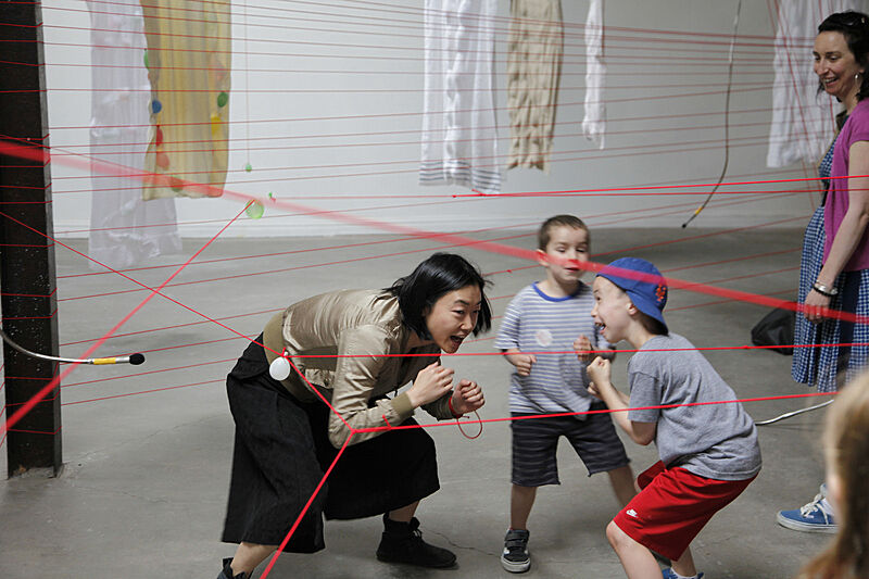 A family and the artist plays in the installation space.