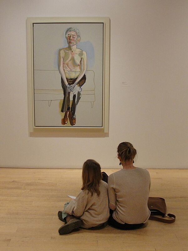 A mother and daughter contemplate art