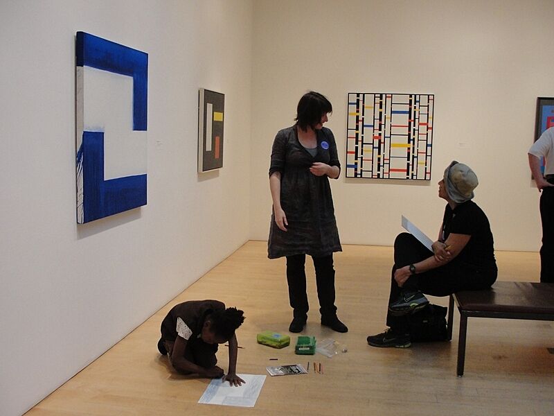 The artist talks to a participant in the gallery