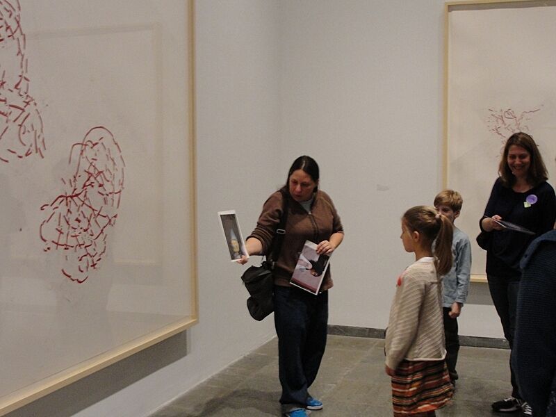 Families look at art in the gallery