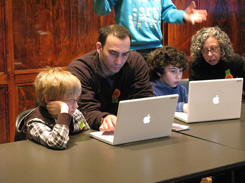A family works on a computer
