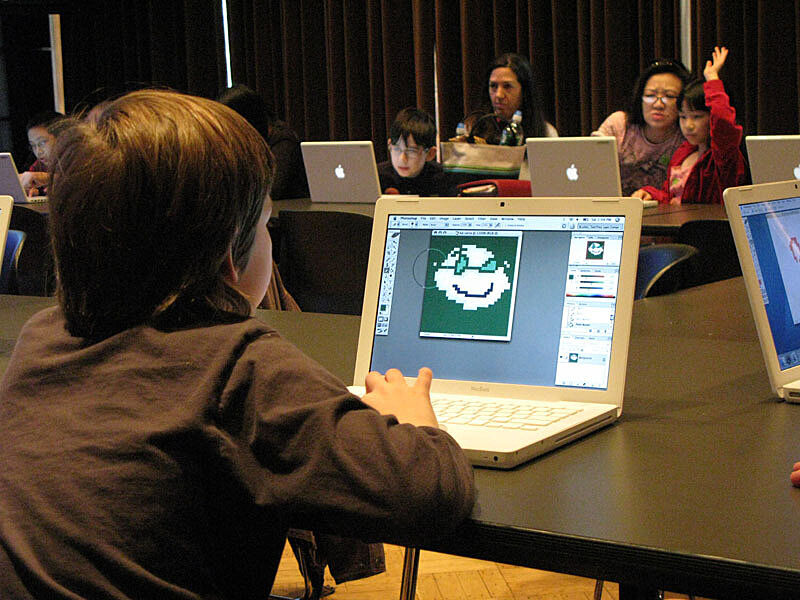 A child creates art on a computer