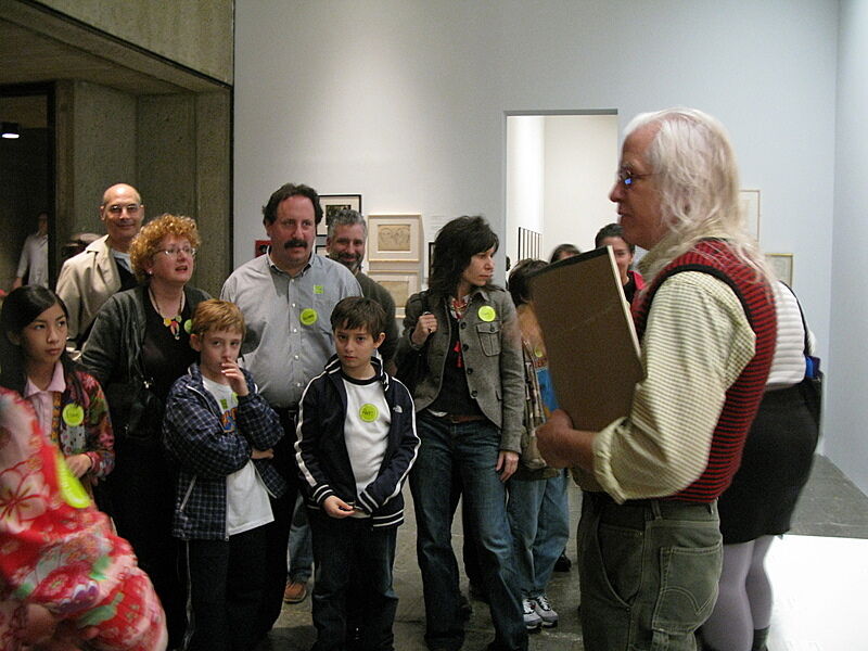 The artist talks with families