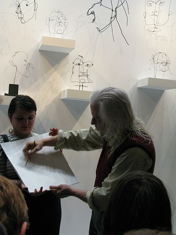 The artist demonstrates a sketch