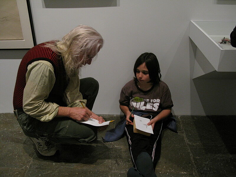 The artist draws with a child
