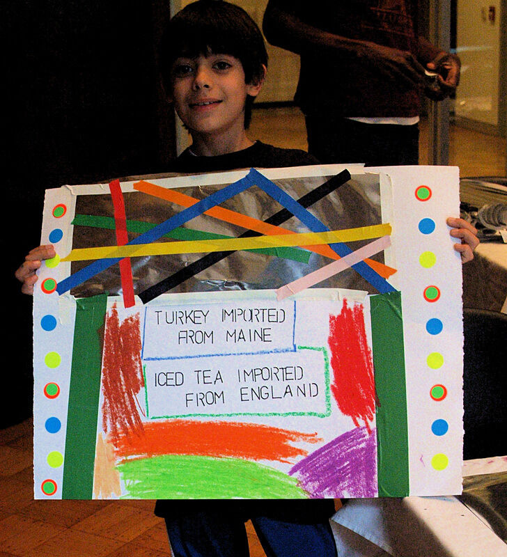 A child shows off his artwork