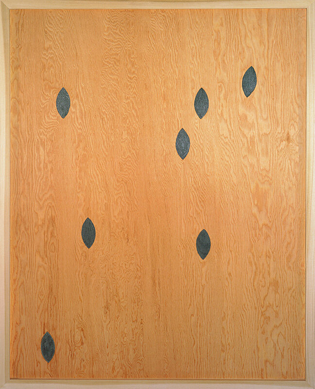 A painting of almond shapes on wood.