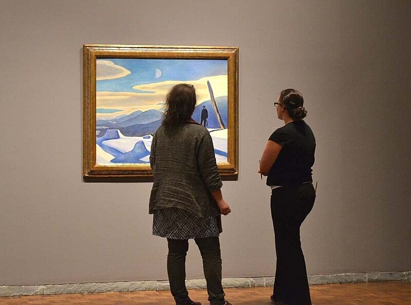 Two teachers looking at a painting