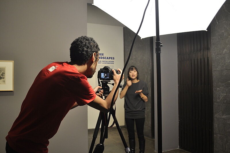 A photo shoot with an educator using sign language.