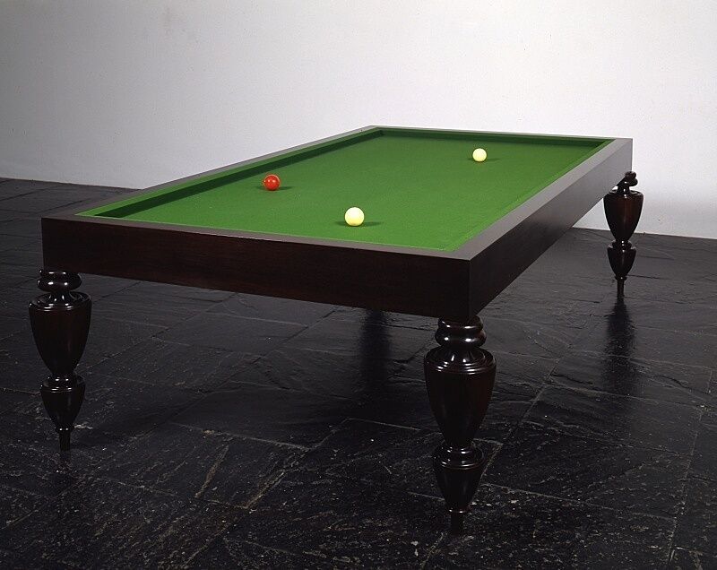 A sculpture resembling a pool table without pockets.