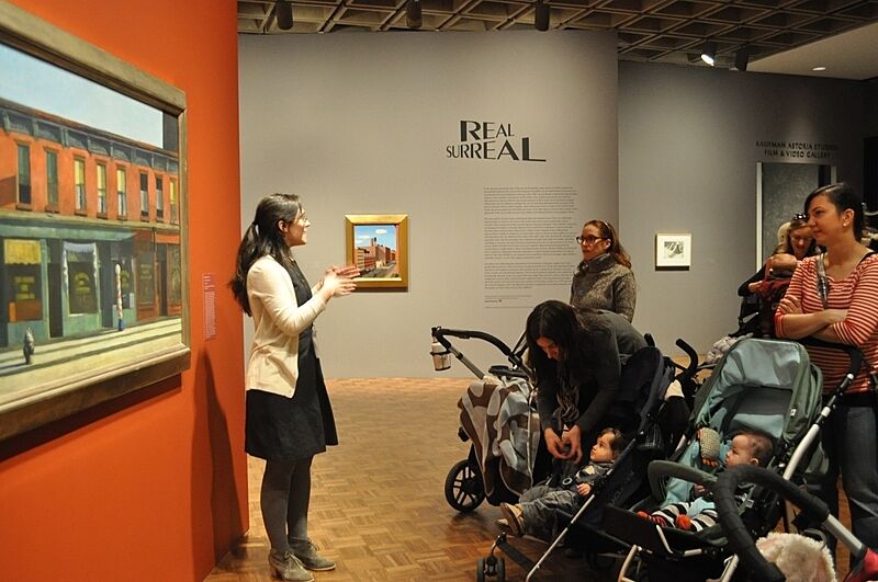 A group with strollers tours the museum