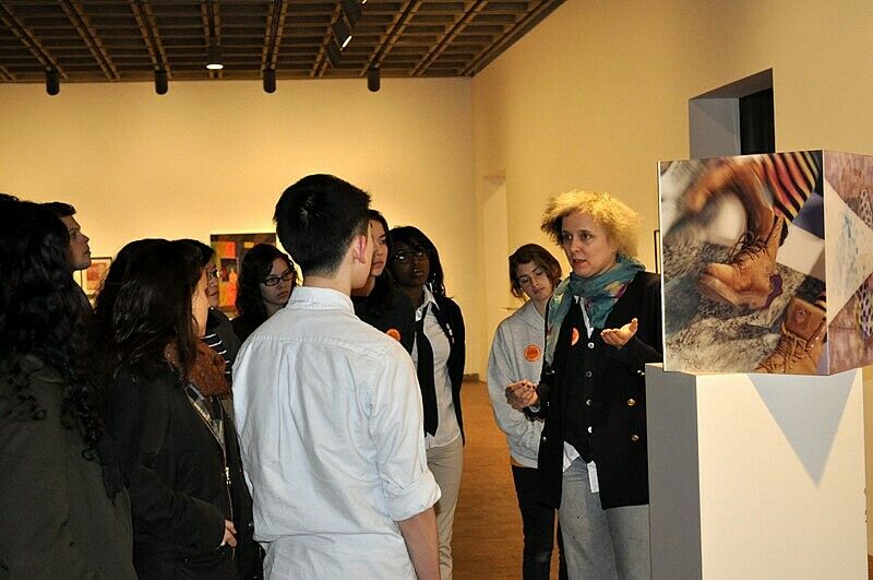 artist standing in front of her art installation